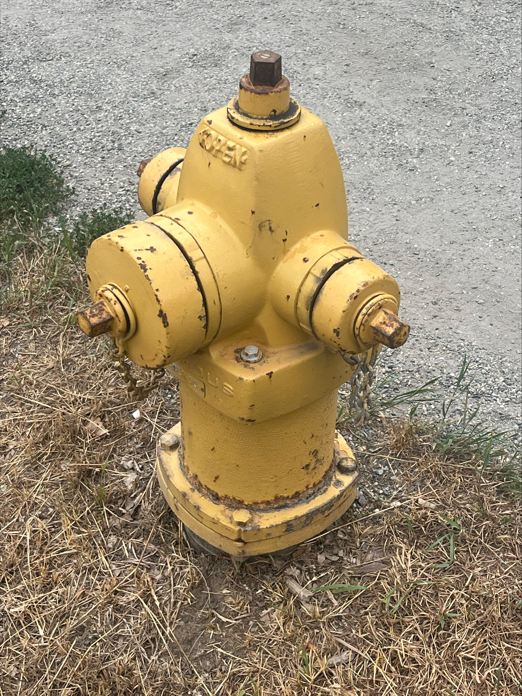 A very useful and Best yellow thing: a fire hydrant with faded, flaking yellow paint